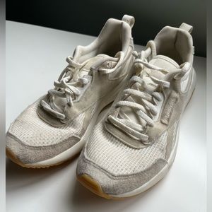 Beige and white gum soled Reebok sneakers